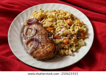Chicken fillet with oriental rice - red background