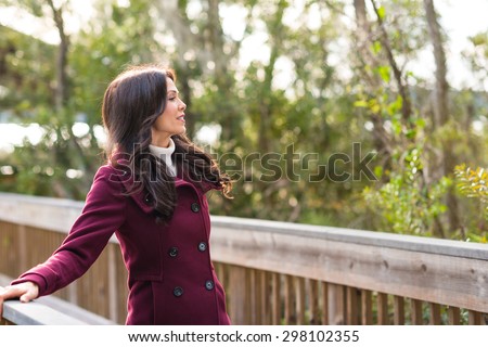 Young woman dressed for cold weather on nature walk