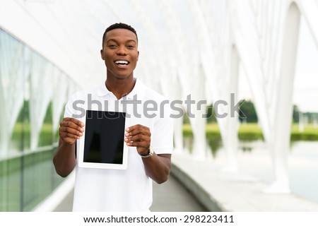 Black, African American college student showing a digital tablet computer