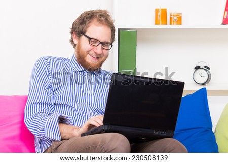 Man chatting by computer with another person