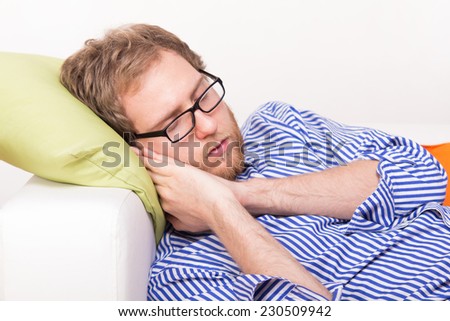Young man sleeping on the couch