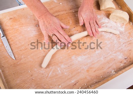 Rolling out the dough on a board in the kitchen - cake preparation