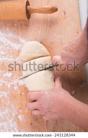 slicing kneaded dough in the kitchen - cake prepraration