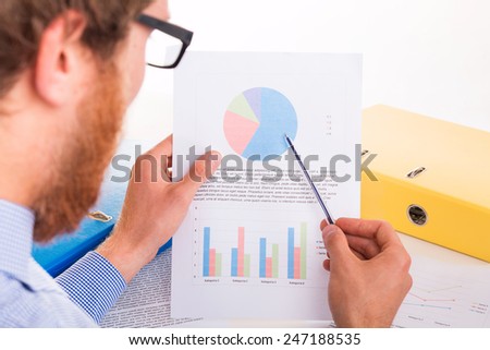 The man in the office shows the report - studio shoot