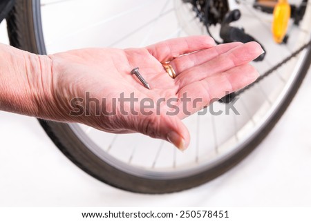 Sharp nail in the wheel of the bicycle - studio shoot