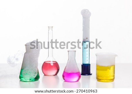 Glass in a chemical laboratory filled with colored liquid during the reaction
