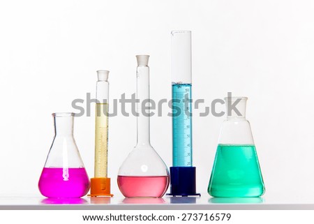 Glass in a chemical laboratory filled with colored liquid during the reaction - studio shoot