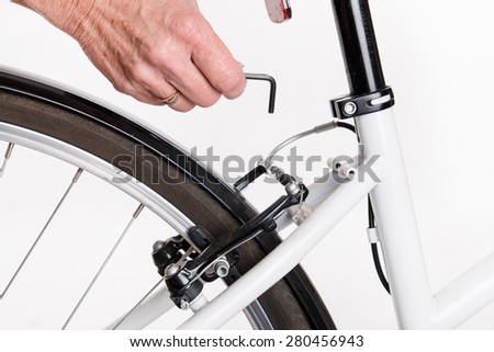 Adjustment and repair of the bike with the allen key - studio shoot