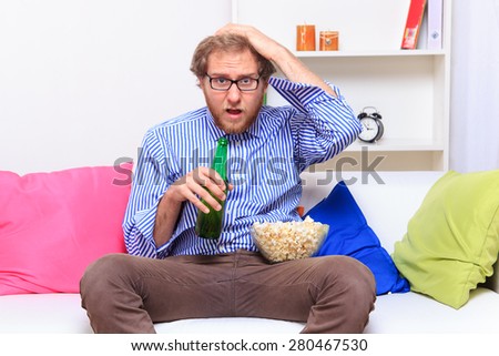 Depressed man on the sofa with beer on the sofa