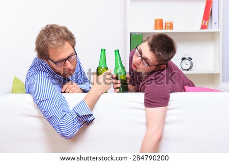 Two drunk guys on the sofa after party