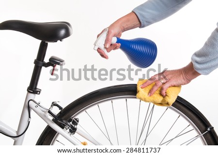 Hands with a cloth and water cleaning bicycle fender - spring cleaning