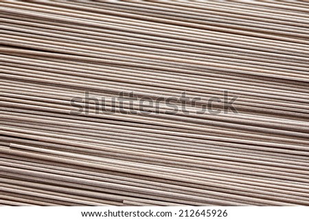 Raw soba noodles background. Selective focus. Soba is a type of thin Japanese noodle made from buckwheat flour. Close-up.