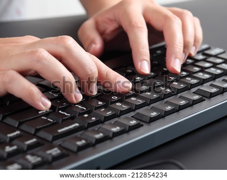 Woman typing on keyboard.