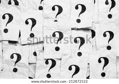 Crumpled paper notes with question marks. Black and White.