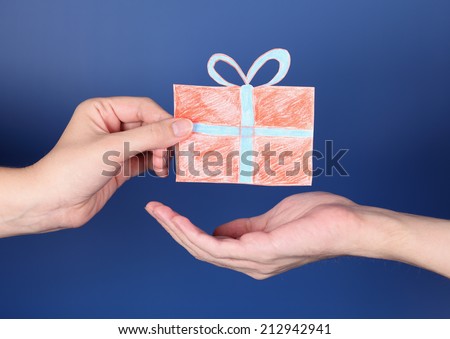 Hand giving a present to another one. Gift box is paper cut-out.