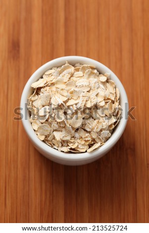 Rolled oats (oat flakes) in a bowl. Closeup.