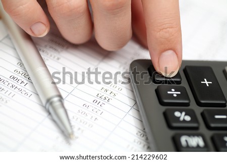 Calculating on a calculator. Financial statements. Closeup.
