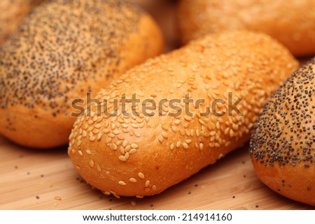 Bread rolls with sesame and rolls with poppy seeds.