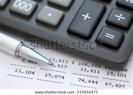 Financial statements. Calculator, ballpoint pen on financial statements.