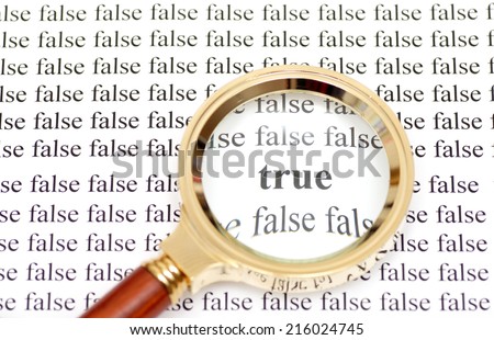 Magnifying glass showing word \'true\' around the words \'false\'