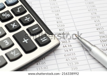 Financial statements. Calculator, ballpoint pen on financial statements.