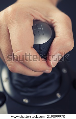 Woman\'s hand shifting manual gears in sport car. Closeup.