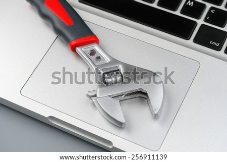 Laptop repair concept. Wrench on a laptop.