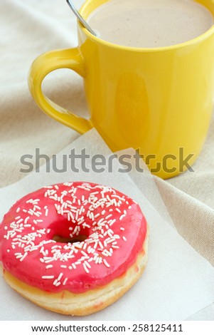 Donut and coffee cup with milk. White coffee.