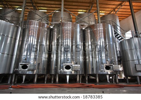 Wine Fermenting in huge vats in a  wine cellar in Spain