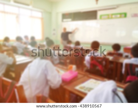 Blur kids and teacher in the classroom for background usage.vintage tone filter.