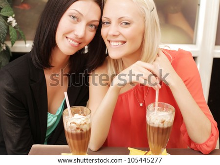 Two young women having coffee break together