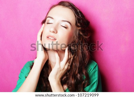 beautiful lady with curly haircut over pink background
