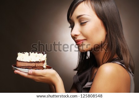The beautiful smiling young woman with a cake