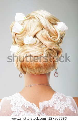Beautiful bride with fashion wedding hairstyle - on white background