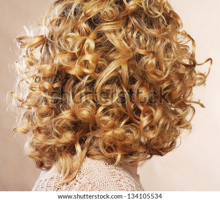 Beautiful female curly blond  hairs - back view