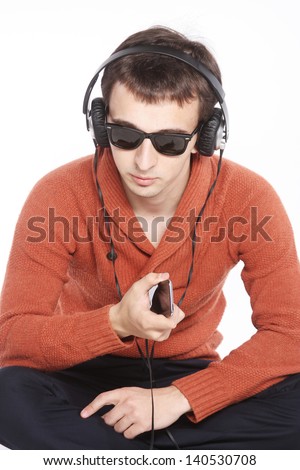 Portrait of a young man listening to music on his headphones