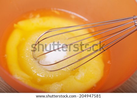Eggs and sugar in mixing bowl prepare for bake. Homemade food.