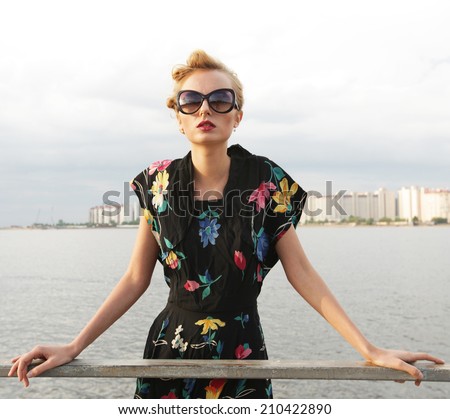 Young fashion model posing near sea.
