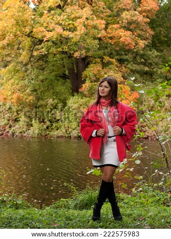 Young  happy woman  near the river in autumn season