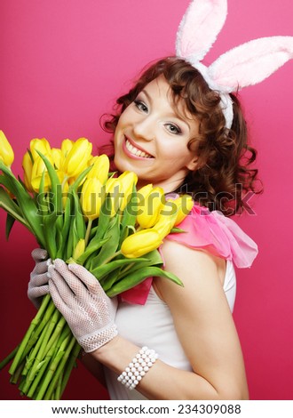 Sexy Woman with Bunny Ears holding yellow tulips