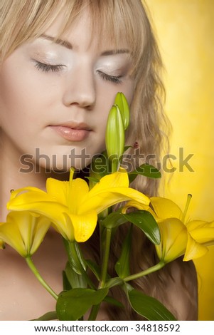 happy woman with yellow flowers on yellow background