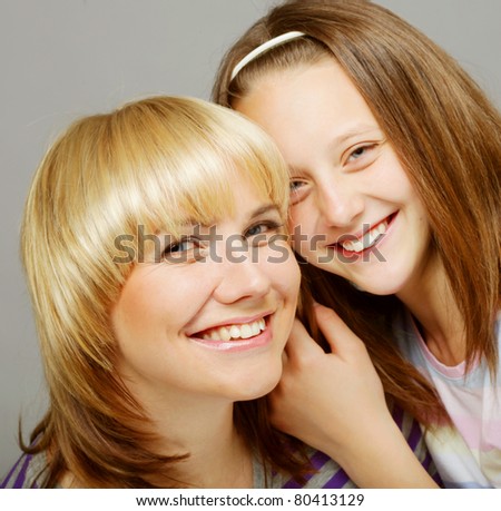 High key portrait of a little girl with her happy mom isolated on white