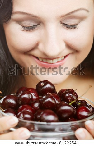 happy  woman with cherries over white
