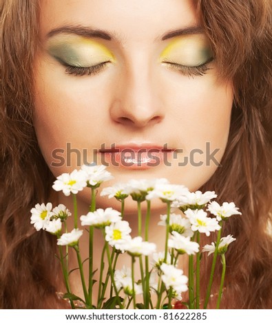 Attractive young woman face with white flowers