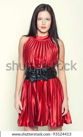 woman in red dress with long dark hair on white background