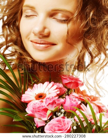 Portrait of  smiling beautiful young woman with bouquet flowers