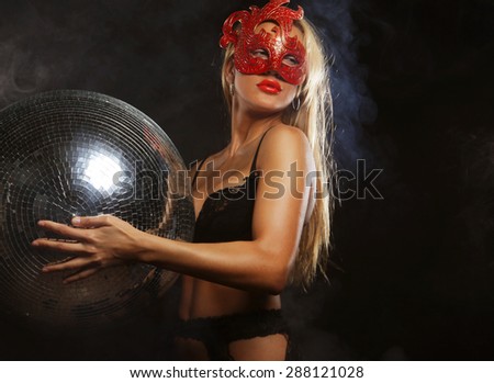 young lady in mask with disco ball