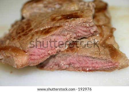 Medium Rare Steak, just out of the frying pan and chopped in half. Can see texture of meat.