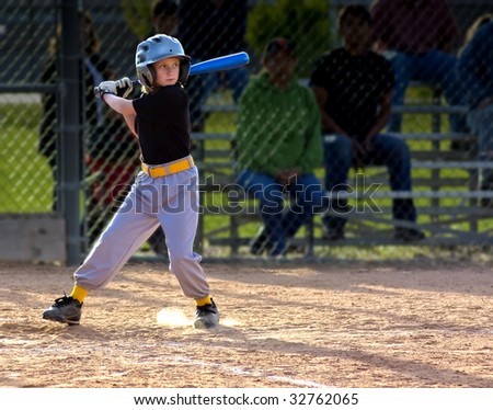 Young Girl Batting at Youth Baseball Game
