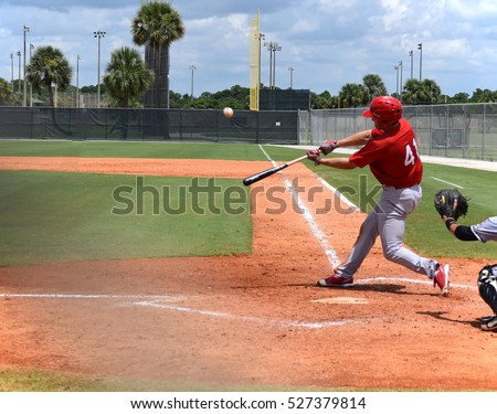 Baseball player in full stride just before he hits the ball for a home run.